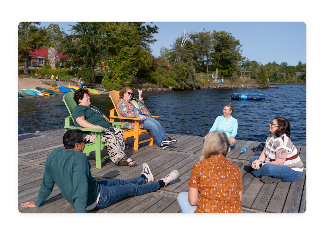 Camp A2X attendees having a lakeside conversation